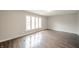 Bright living room with hardwood floors, large windows, and ample natural light at 1823 E 44Th St, Anderson, IN 46013