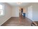 Spacious living room with wood floors, neutral walls, and adjacent kitchen island at 1823 E 44Th St, Anderson, IN 46013