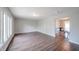 Bright, open-concept living room with dark wood floors, large windows, and neutral paint at 1823 E 44Th St, Anderson, IN 46013