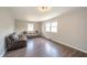 Cozy living room featuring wood floors, neutral walls, and comfortable leather seating at 1823 E 44Th St, Anderson, IN 46013