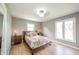 Cozy main bedroom featuring hardwood floors and large windows at 1823 E 44Th St, Anderson, IN 46013