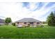 Backyard with a stone patio, lush green lawn, and landscaped mulch beds at 1893 Water Oak Way, Avon, IN 46123