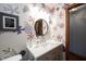 Stylish bathroom with fun floral wallpaper, updated sink and fixtures, and modern lighting at 1893 Water Oak Way, Avon, IN 46123