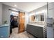 Bathroom featuring dual sinks, granite countertops, and walk-in closet with sliding barn door at 1893 Water Oak Way, Avon, IN 46123