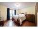 Cozy bedroom features hardwood floors, wood furnishings, and a bright window at 1893 Water Oak Way, Avon, IN 46123