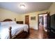 Cozy bedroom features hardwood floors, wood furnishings, and warm neutral paint at 1893 Water Oak Way, Avon, IN 46123