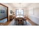 Sunlit dining room features a large window, elegant chandelier, and a classic wooden dining set at 1893 Water Oak Way, Avon, IN 46123