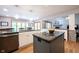 Open floor plan showing stone fireplace and island with granite countertop at 1893 Water Oak Way, Avon, IN 46123