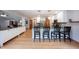 Open kitchen view showing island with seating and built-in white cabinets at 1893 Water Oak Way, Avon, IN 46123