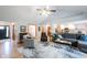 Open-concept living room with hardwood floors connects to the kitchen and dining areas at 1893 Water Oak Way, Avon, IN 46123