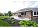 Brick home featuring a patio, outdoor seating, landscaping, and manicured lawn at 1893 Water Oak Way, Avon, IN 46123