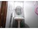 This unique powder room features playful wall decor, a pedestal sink, and modern fixtures at 1893 Water Oak Way, Avon, IN 46123