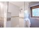 Beautiful shower features white tile with glass surround and decorative tile accent at 1893 Water Oak Way, Avon, IN 46123