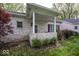 Charming home with a white-washed brick exterior and a covered patio, nestled in a lush yard at 1920 E 81St St, Indianapolis, IN 46240