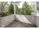 Back patio area featuring an attractive retaining wall and a view of a well-maintained yard at 1920 E 81St St, Indianapolis, IN 46240