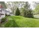 Spacious backyard featuring mature trees, lush greenery, and white picket fence at 1920 E 81St St, Indianapolis, IN 46240