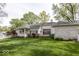 Well-maintained backyard with mature trees, green grass, and white picket fence at 1920 E 81St St, Indianapolis, IN 46240