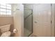 Bathroom with a new shower enclosure next to a white six panel door and a window at 1920 E 81St St, Indianapolis, IN 46240