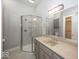 Bathroom featuring a glass enclosed shower, grey vanity and a large mirror with vanity lights at 1920 E 81St St, Indianapolis, IN 46240
