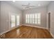 Bedroom with hardwood floors, ceiling fan, and large windows with plantation shutters at 1920 E 81St St, Indianapolis, IN 46240