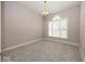 Neutral bedroom with grey carpet, large window, and decorative lighting fixture and chandelier at 1920 E 81St St, Indianapolis, IN 46240