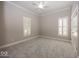 Light filled bedroom with two sunny windows, crown molding, ceiling fan and neutral grey walls at 1920 E 81St St, Indianapolis, IN 46240