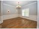 Dining room features elegant chandelier, hardwood floors and decorative wall trim at 1920 E 81St St, Indianapolis, IN 46240