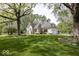 Stunning brick home with manicured lawn, mature trees, and three car garage at 1920 E 81St St, Indianapolis, IN 46240
