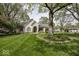 Charming home with manicured lawn, mature trees, and an inviting entrance at 1920 E 81St St, Indianapolis, IN 46240
