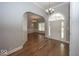 Elegant foyer with hardwood floors, arched doorways, and chandelier lighting at 1920 E 81St St, Indianapolis, IN 46240