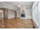 Spacious living room featuring hardwood floors, fireplace with built-ins, and ample natural light at 1920 E 81St St, Indianapolis, IN 46240
