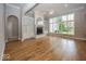 Bright living room featuring hardwood floors, fireplace with built-ins, and large windows at 1920 E 81St St, Indianapolis, IN 46240