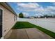A well-maintained backyard with a green lawn, bordered by a white fence, and a concrete patio area at 2260 Quarter Path Rd, Cicero, IN 46034