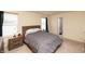 Bright bedroom with a wooden headboard, soft carpet, and natural light from two windows at 2260 Quarter Path Rd, Cicero, IN 46034