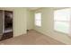 Neutral-toned room featuring two windows, carpet, and a view of the next room through an open door at 2260 Quarter Path Rd, Cicero, IN 46034