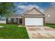 Charming single-Gathering home with brick accents, a two-car garage, and well-maintained landscaping at 2260 Quarter Path Rd, Cicero, IN 46034