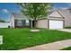 Well-manicured front lawn with a lovely tree, green shutters, and a brick and siding exterior at 2260 Quarter Path Rd, Cicero, IN 46034