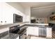 Well-equipped kitchen with granite countertops, stainless steel appliances, and white cabinetry at 2260 Quarter Path Rd, Cicero, IN 46034