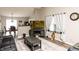Cozy living room with wood floors, a modern rug, and a view of the dining area and kitchen at 2260 Quarter Path Rd, Cicero, IN 46034