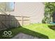 Backyard featuring a wooden fence, green grass, and a trampoline at 2277 Grand Fir Dr, Greenwood, IN 46143