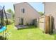 Backyard featuring a trampoline, privacy fence, and sliding glass doors to the home at 2277 Grand Fir Dr, Greenwood, IN 46143