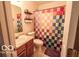 Cozy bathroom featuring a colorful shower curtain, toilet, vanity, and wall decor at 2277 Grand Fir Dr, Greenwood, IN 46143