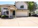 Charming two-story home with a two car garage, front porch, neutral siding, and a well maintained driveway at 2277 Grand Fir Dr, Greenwood, IN 46143