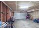 View of a garage with an open door and a white concrete floor, showing bicycles and ample storage at 2277 Grand Fir Dr, Greenwood, IN 46143
