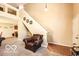 Comfortable chair in living room with staircase and neutral carpet at 2277 Grand Fir Dr, Greenwood, IN 46143