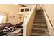 Comfortable living room with leather seating, a staircase, and loft area above the living room at 2277 Grand Fir Dr, Greenwood, IN 46143