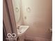 Clean powder room with pedestal sink and simple decor at 2277 Grand Fir Dr, Greenwood, IN 46143