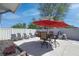 Backyard patio seating area featuring a large red umbrella, perfect for outdoor entertaining at 2305 Caldwell Pl, Columbus, IN 47201