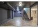 Basement area featuring carpet and tile flooring, neutral paint, and stairway at 2305 Caldwell Pl, Columbus, IN 47201