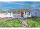 A cozy one-story house with a lovely porch swing, colorful door, and well-maintained lawn at 2305 Caldwell Pl, Columbus, IN 47201